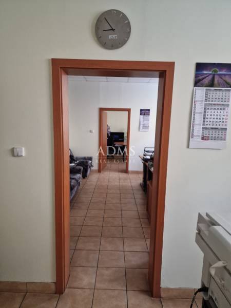 Office spaces with tiles, wooden door frames, and wall clocks in warehouses and halls.