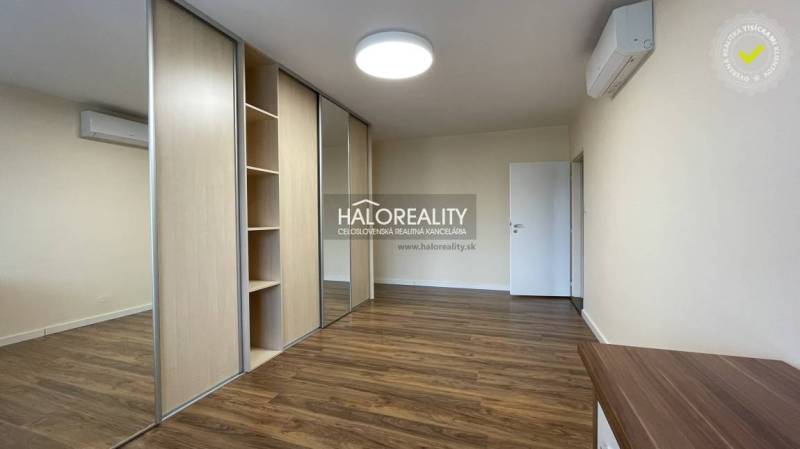 Interior of a 3-room apartment with a wooden decor floor and a built-in wardrobe.