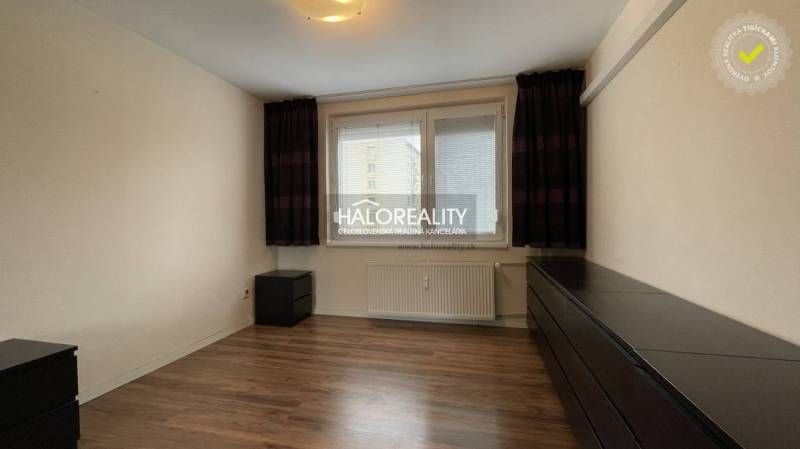 A room in a 3-room apartment with a wooden decor floor and white walls.