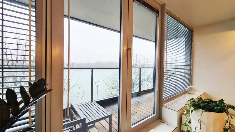 Winter garden with a view of the balcony and river in a 3-room apartment.