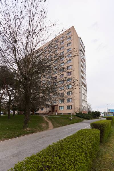 An apartment building surrounded by trees and a hedge on Štítová Street in Košice, Staré Mesto district.