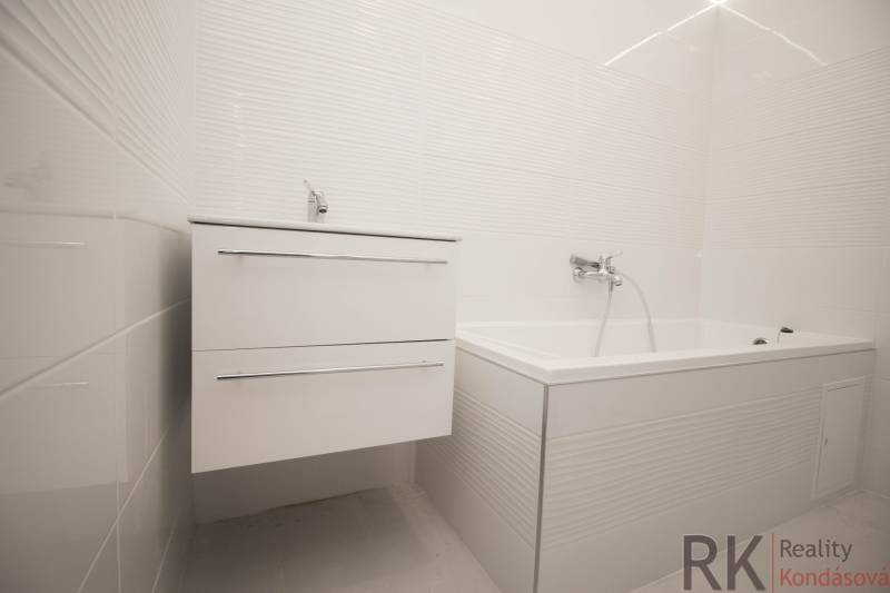 Elegant bathroom with a white sink and bathtub in a 2-room apartment.