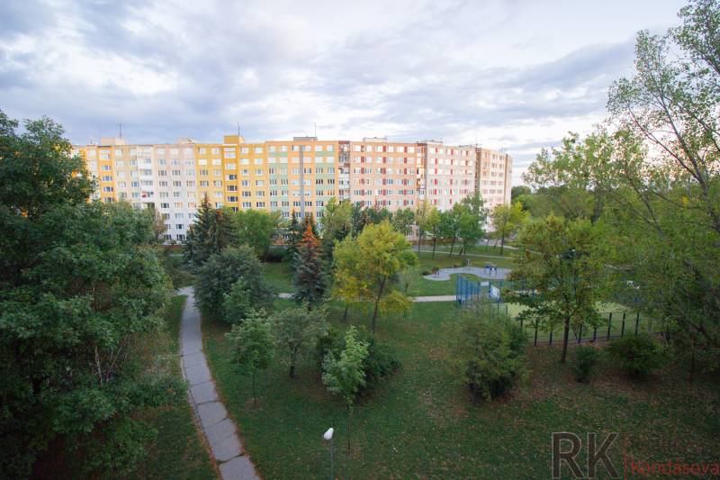 A large apartment building surrounded by trees and well-maintained walkways on Krakovská in Košice.