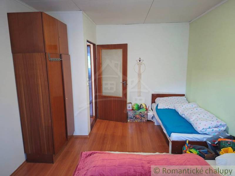 Children's room in a family house with a wooden decor floor and toys.