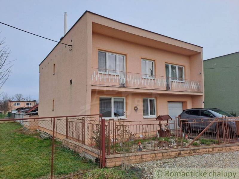 A family house in Veľké Ripňany with a balcony and a landscaped yard.