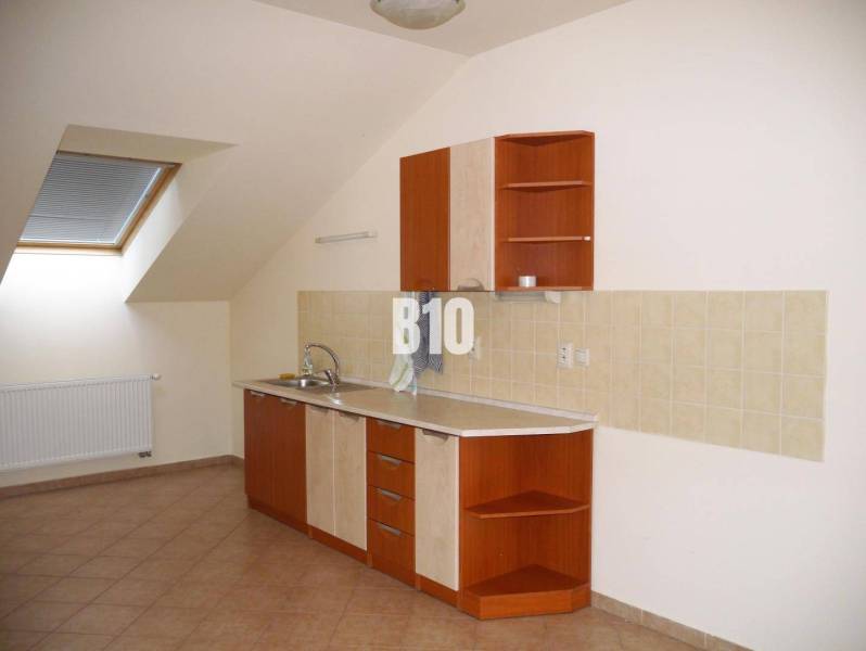 Attic kitchen with kitchen unit, tiles, and skylight ideal for offices.