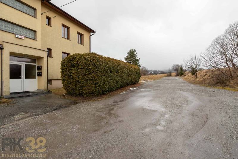 Exterior of a 5 or more bedroom apartment in Stará Lesná with visible bushes and a road.