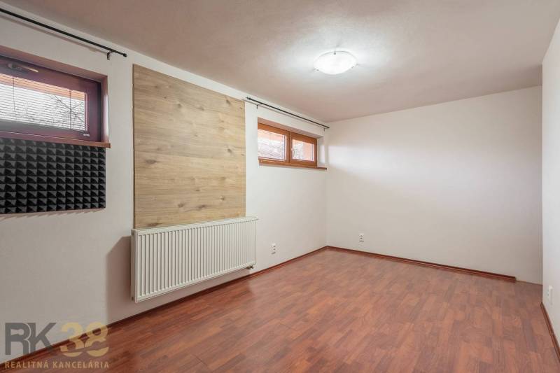 A room with a wooden decor floor and sound insulation in a 5 or more room apartment.
