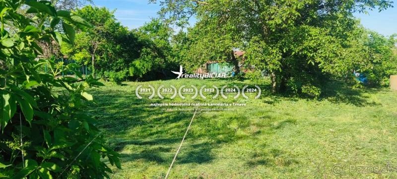 Grassy plots for living in Dolné Dubové with abundant greenery and trees.