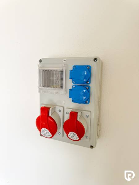 Electrical installation panel with industrial sockets in commercial premises.