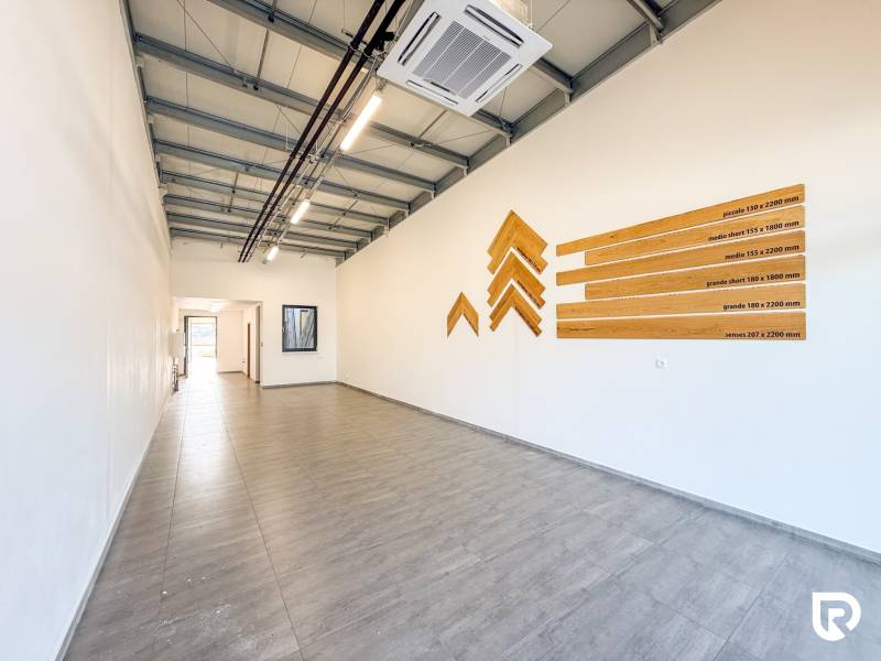 Commercial spaces with wood-patterned flooring and wall decoration.