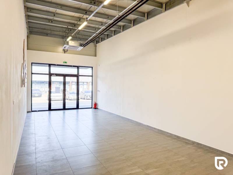 Spacious commercial premises with tiles and large doors.