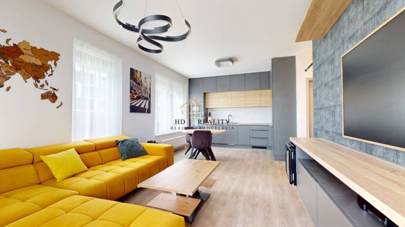 Living room in a 3-room apartment with a wooden decor floor and a yellow sofa.