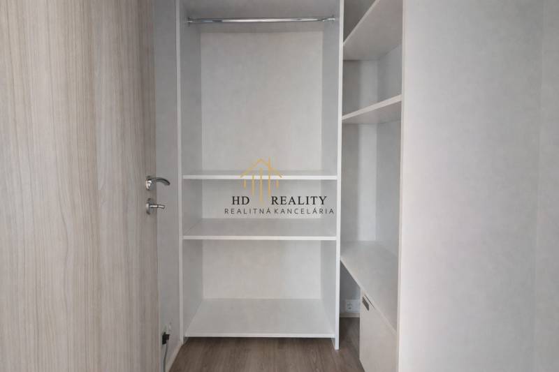 Built-in wardrobe in a 3-room apartment with a wooden decor floor.