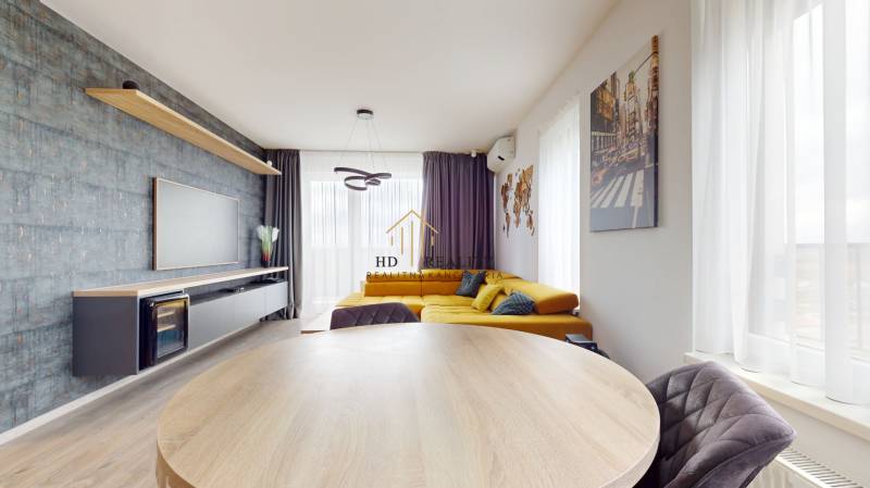 Living room with a corner sofa and television, wooden decor flooring, 3-room apartment.
