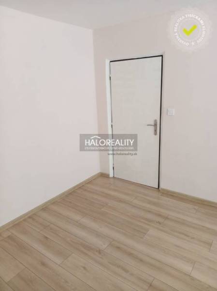 Bathroom in a 3-room apartment with a sink, toilet, and floor with a wooden decor.