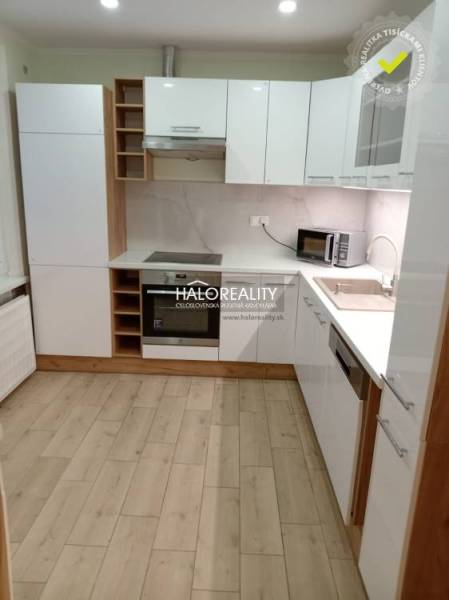 Entrance hall in a 3-room apartment with a round mirror and wooden decor flooring.