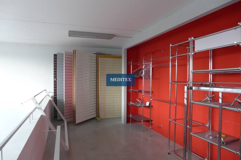 A store with metal shelves and stands in commercial premises.