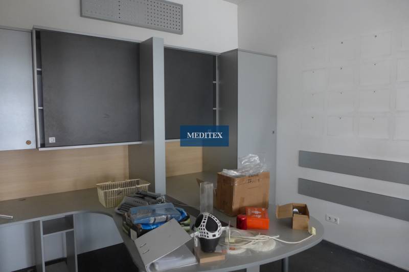 Office with storage cabinets and a desk with various items on it.