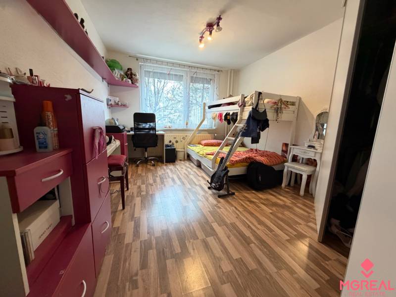 Children's room with a cabinet, bunk bed, and floor with wooden decor in a 3-room apartment.