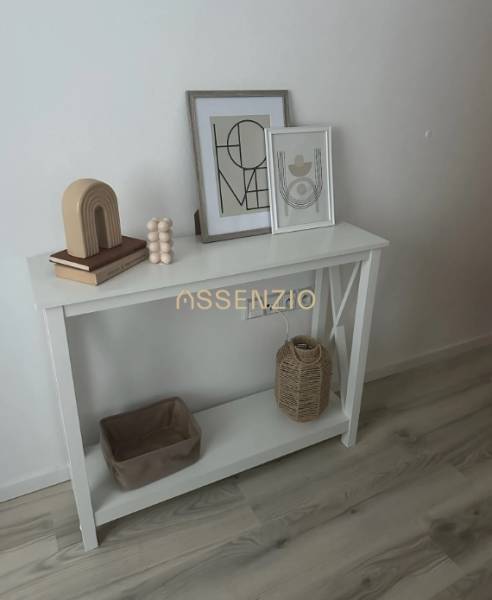 White console with decorations, wooden floor decor, 2-room apartment.