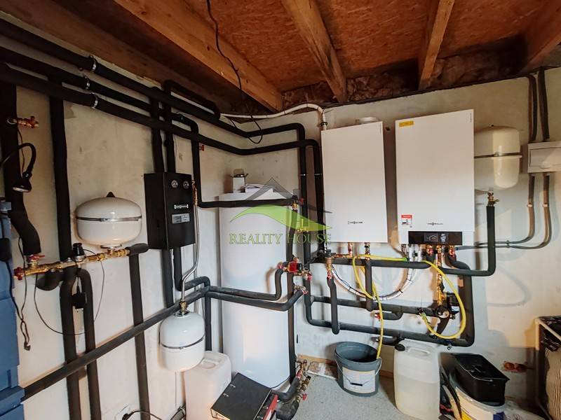 Heating system in a family house with interconnected pipes and a boiler.