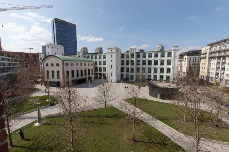 Courtyard with a historic building, modern elements, and greenery in Bratislava on Páričkova Street.