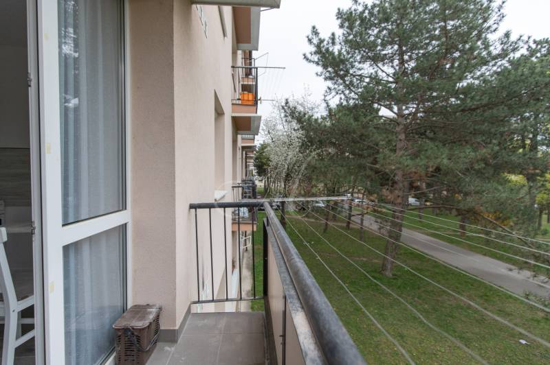 The balcony of an apartment building on Planét Street in Bratislava - Ružinov with a view of greenery.
