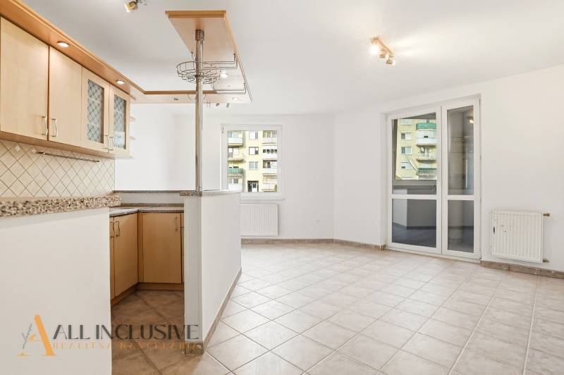A kitchen with a bar counter and tiled floor in a two-room apartment.