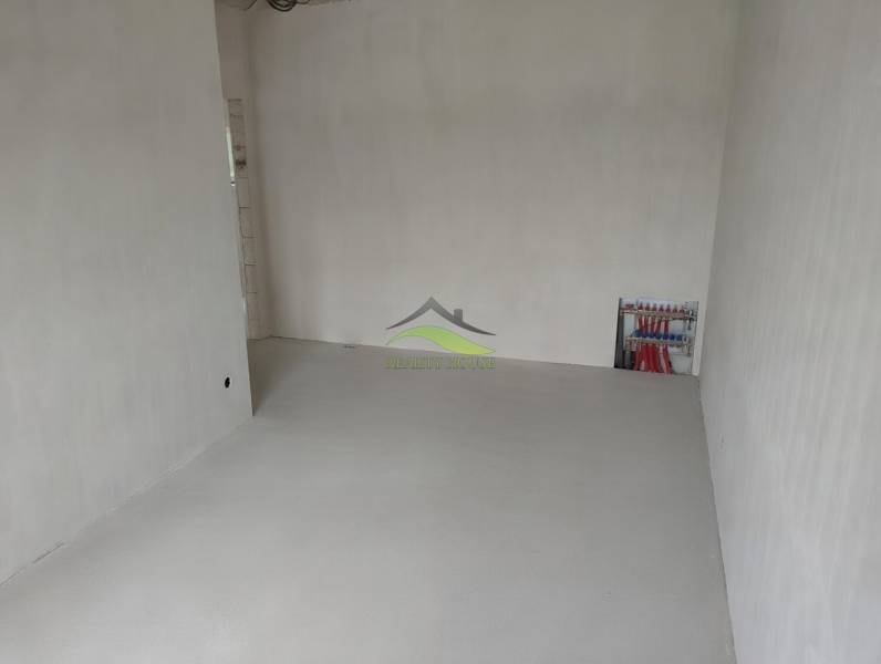 Spacious room with white walls and wiring in a family house.