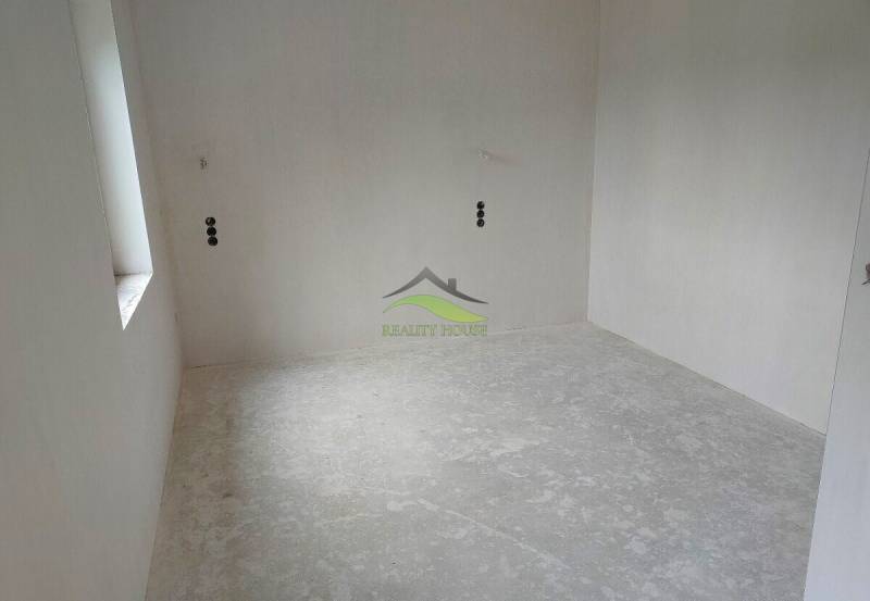 Empty room with a concrete floor in a family house.