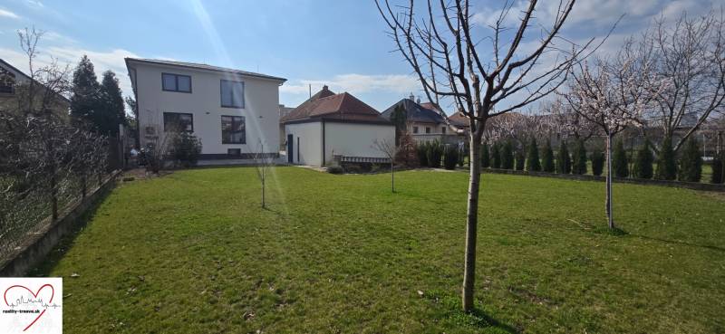 Garden at a 3-room apartment on Gábora Steinera Street, Trnava, with young trees.