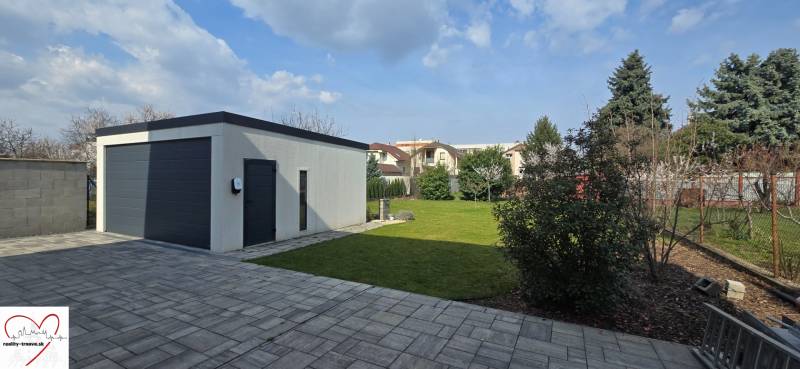 Garage and green yard in Trnava on Gábora Steinera Street near a 3-room apartment.
