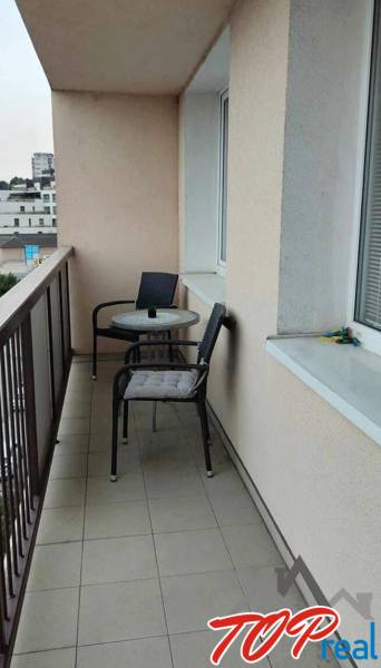 A balcony in a 3-room apartment with two chairs and a table, Žižkova, Košice - Juh district.