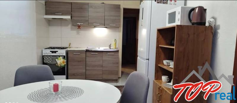 Kitchen in a 3-room apartment with a table, chairs, and a kitchen unit.