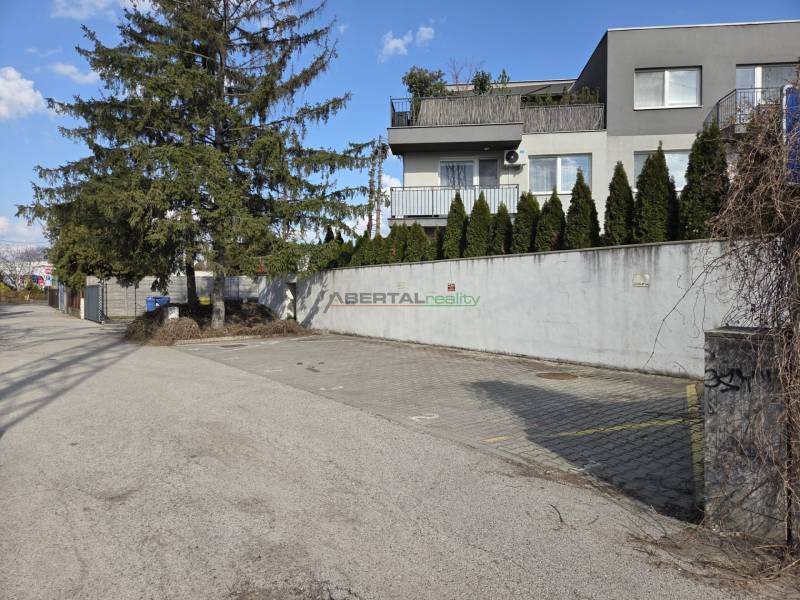 Garages on Vavrínova Street in Bratislava - Ružinov with surrounding greenery and houses.