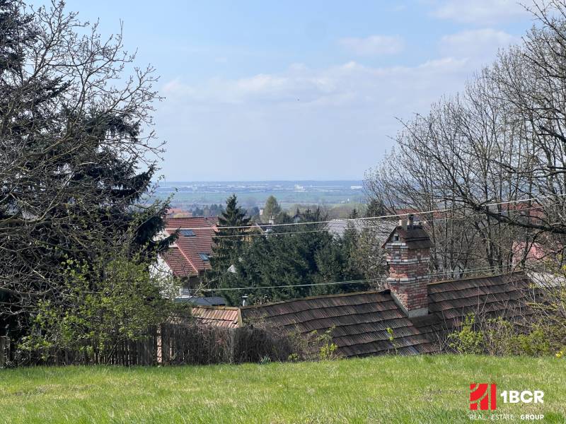 Gardens with a view between trees and rooftops on Budovateľská Street, Marianka, Residential plots.