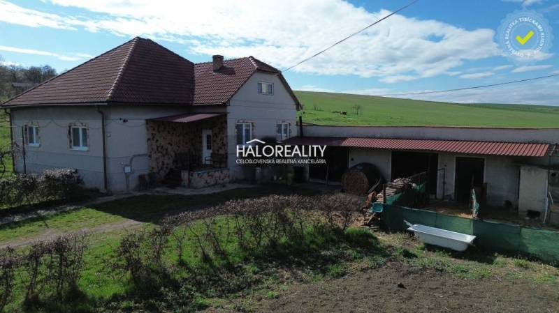 A family house in Rimavské Janovce, with a red roof and a spacious garden.