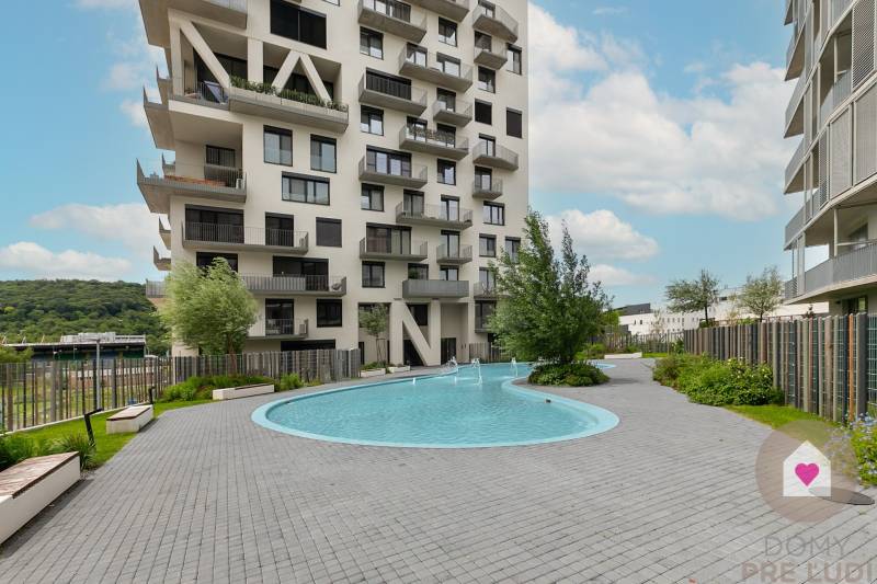 Residential complex with a swimming pool on Polianky Street in Bratislava, Dúbravka, surrounded by greenery.