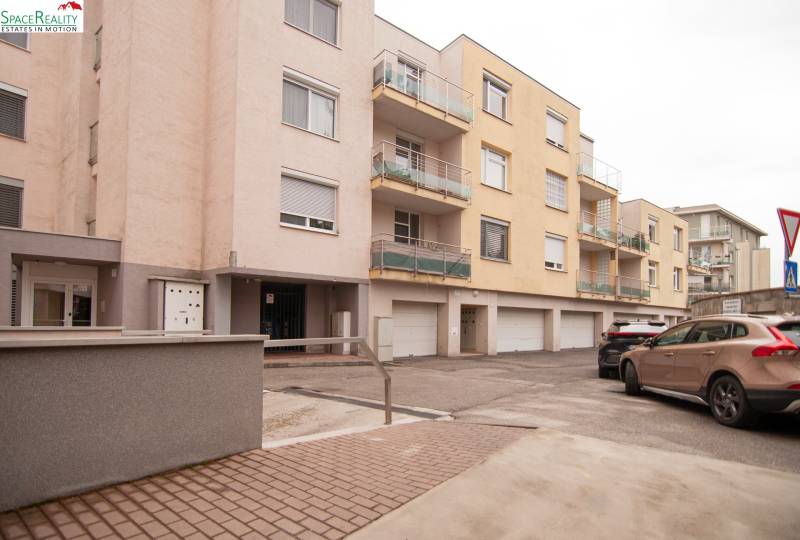 Apartment building on Na pažiti Street, Bratislava - Nové Mesto, with a parking lot and balconies.