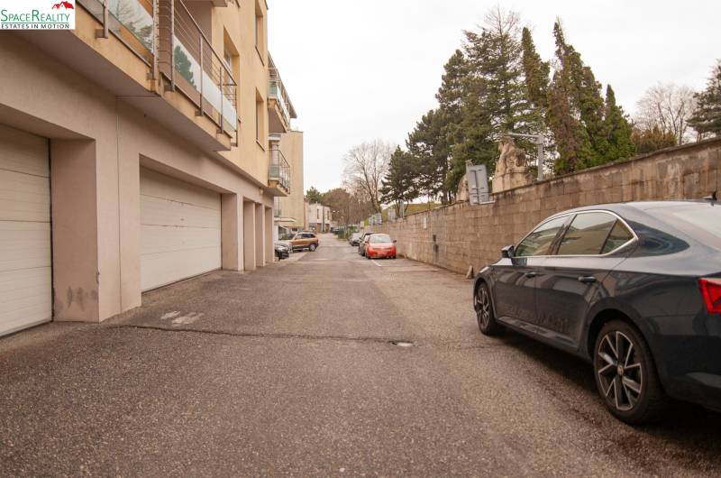 Na pažiti Street, Bratislava - Nové Mesto, shows a parking lot and residential buildings with garages.