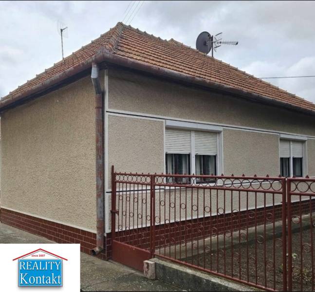 A family house in Radava on Hlavná Street with a red roof and white shutters.