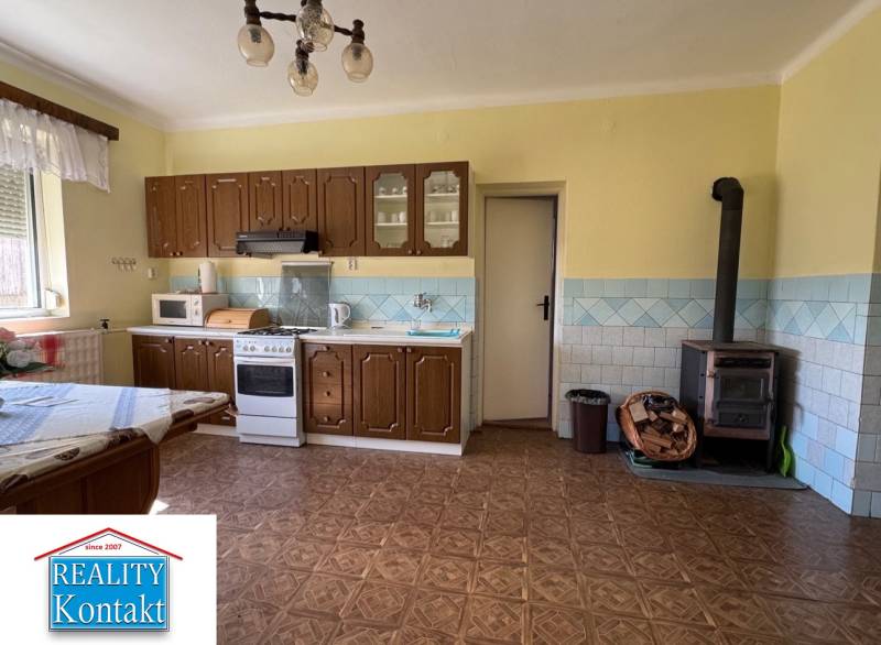 A kitchen in a family house with a wooden floor decor and traditional interior.