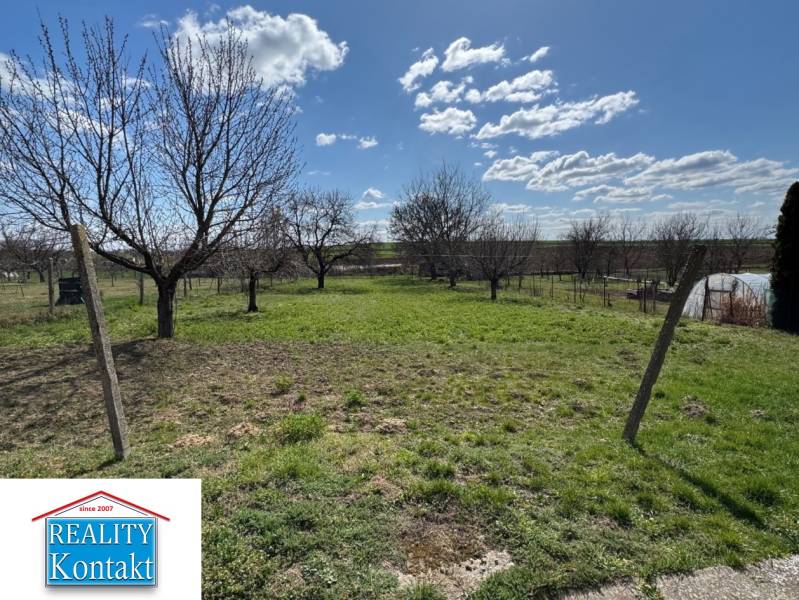 A garden at a family house on Hlavná Street in Radava with fruit trees and a lawn.