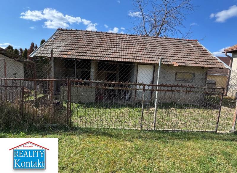 A family house on Hlavná Street in Radava with simple fencing and a lawn.
