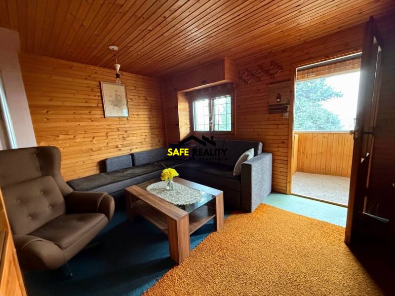 Interior of a cabin with seating and wooden paneling.