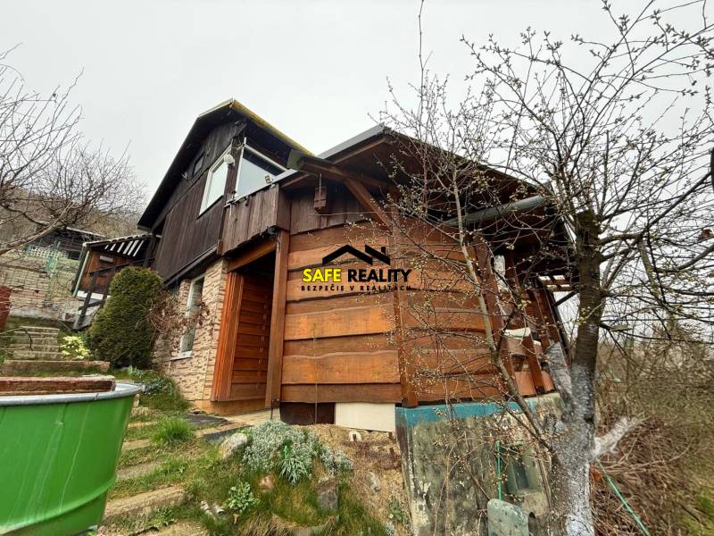 A cottage near Žilina with stairs, wooden paneling, and proximity to nature.