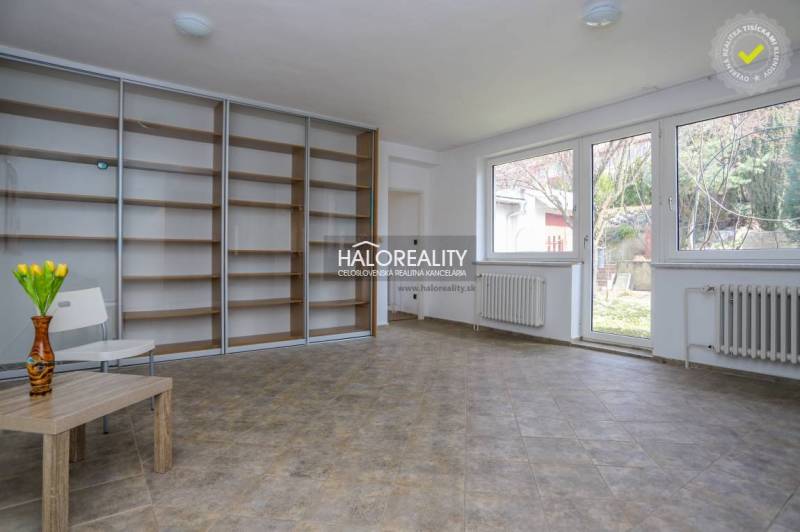 A spacious room in a family house with large windows and a built-in wardrobe.