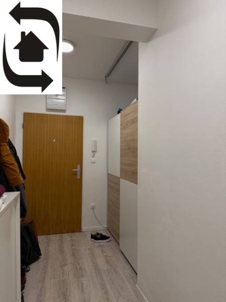 Entrance hallway in a 2-room apartment, white walls and doors, floor with wood decor.