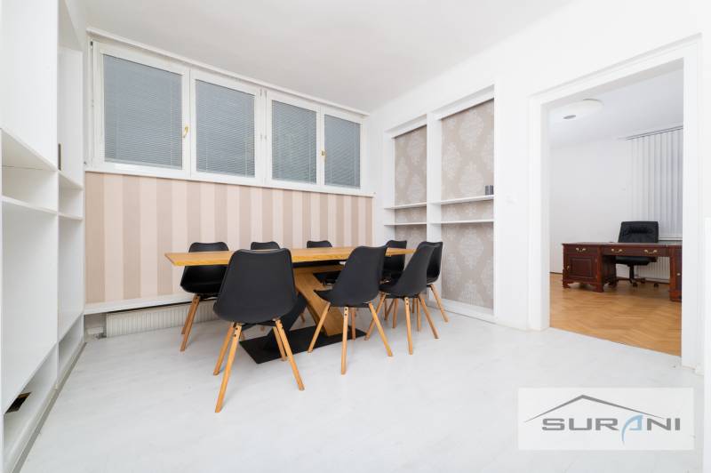 Dining area with a table and chairs, next to an office with a desk, 4-room apartment.